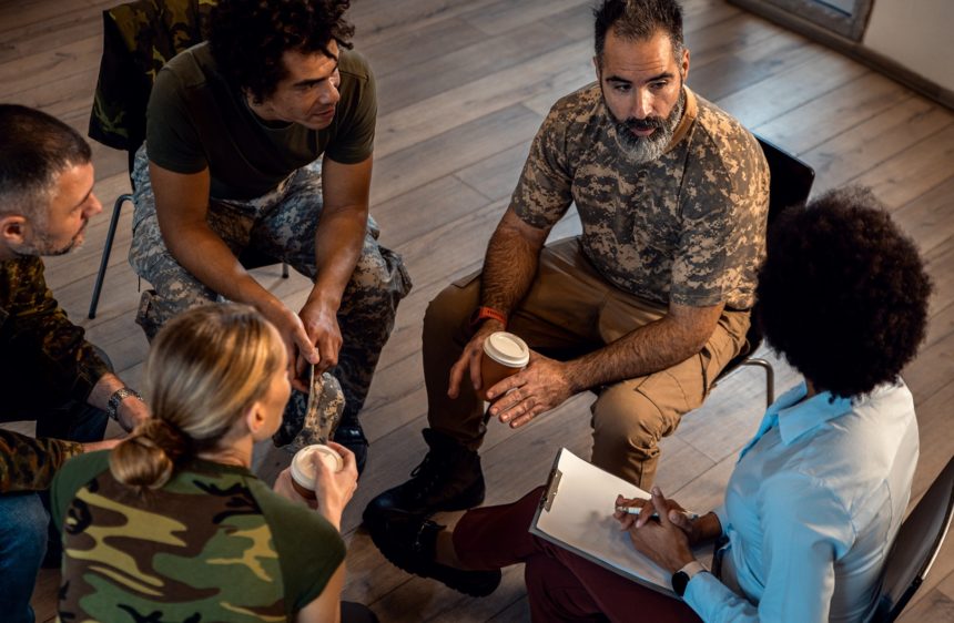 Group of diverse veterans talking during PTSD support group. Countdown to 250: The Americans Building Tomorrow