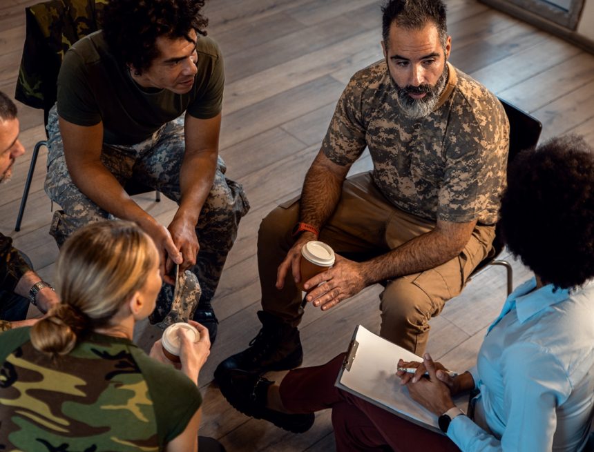 Group of diverse veterans talking during PTSD support group. Countdown to 250: The Americans Building Tomorrow